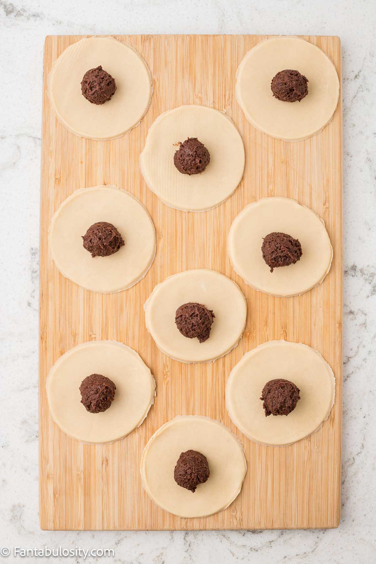 Pie crust circles cut out and chocolate pudding in center of each.