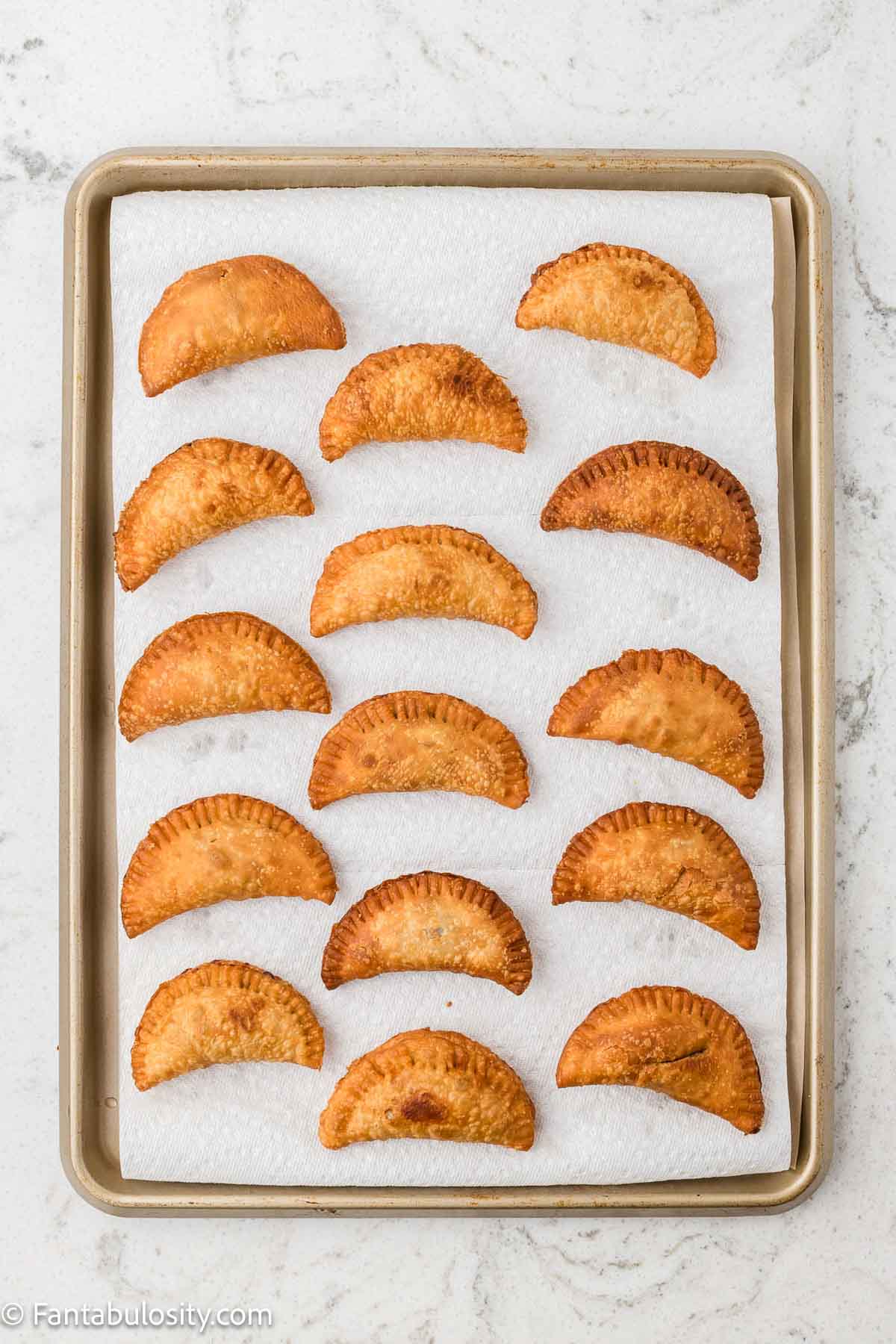 Fried chocolate pies on baking sheet.
