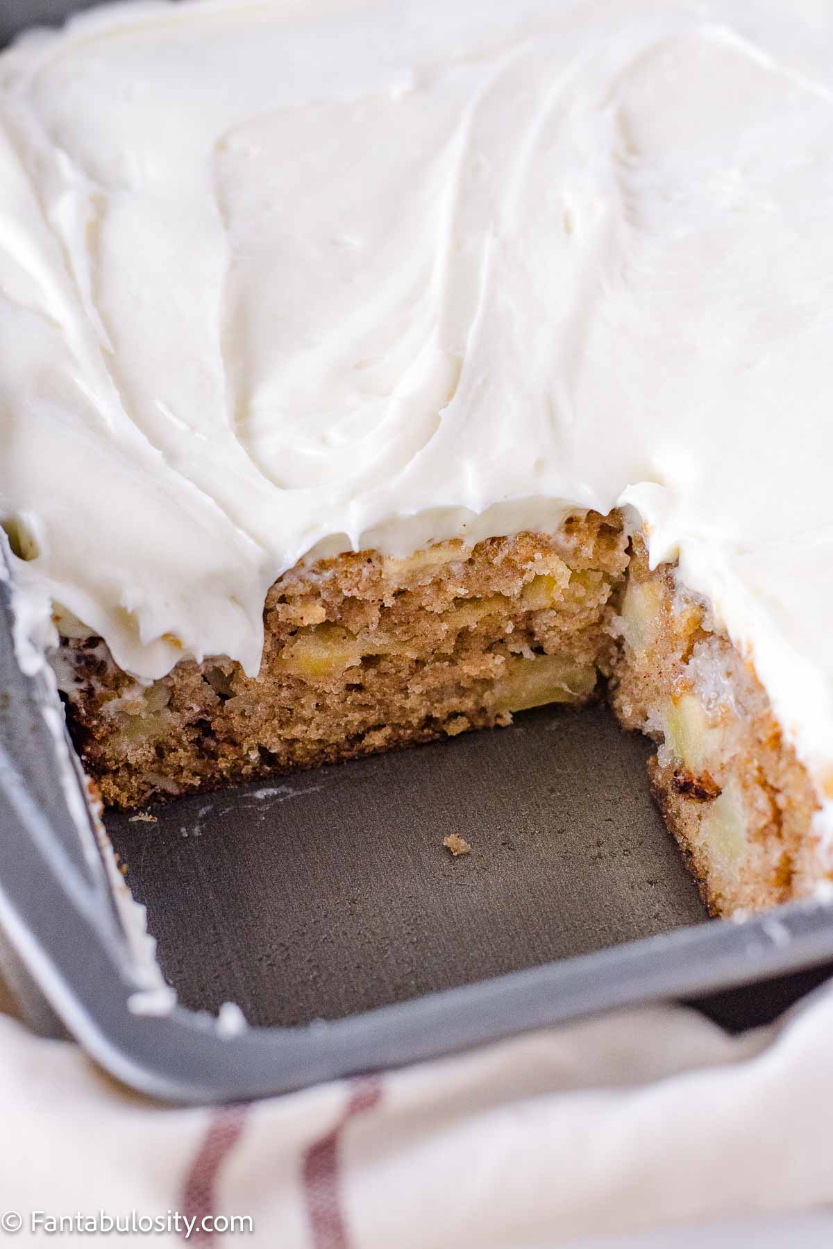 Harvest cake with a piece of cake removed to see the cake and frosting.