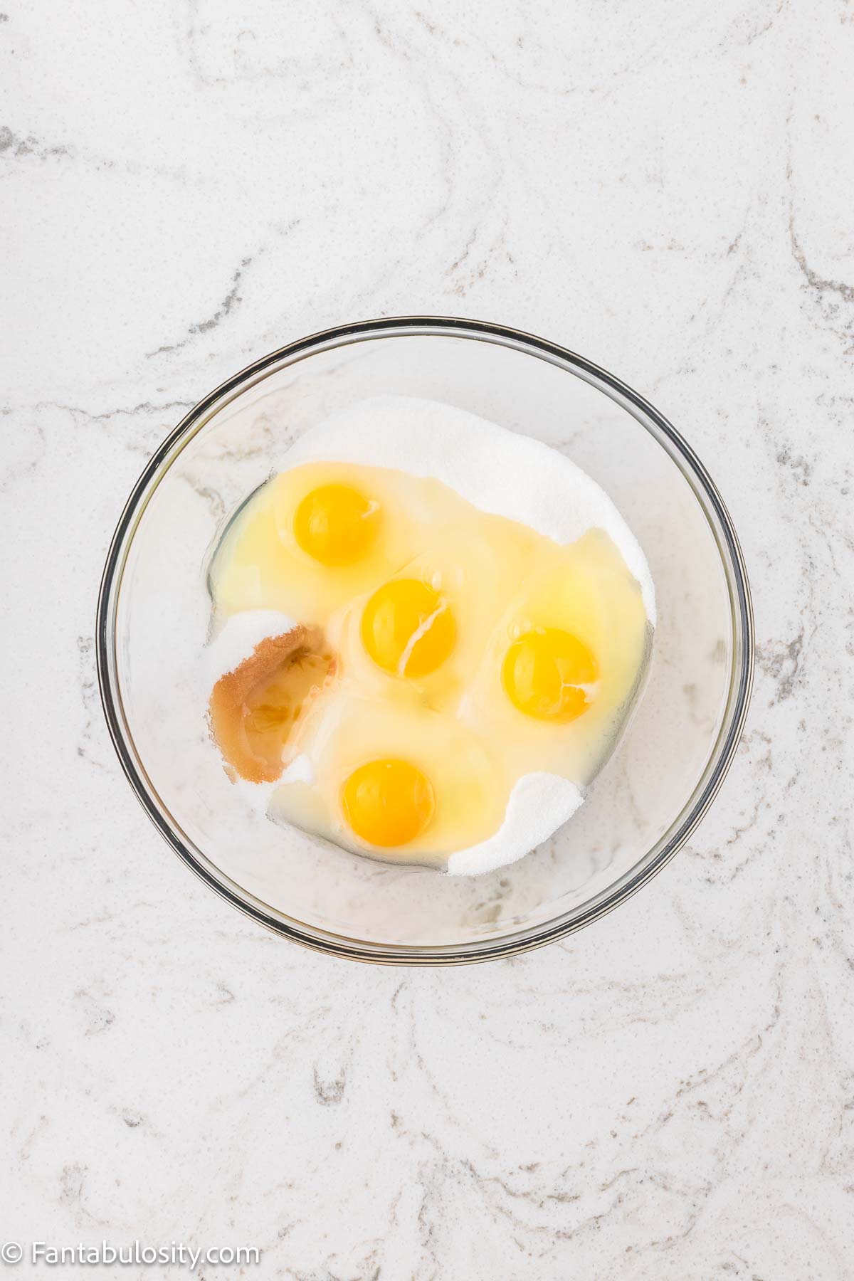 Eggs, sugar and vanilla added to mixing bowl.