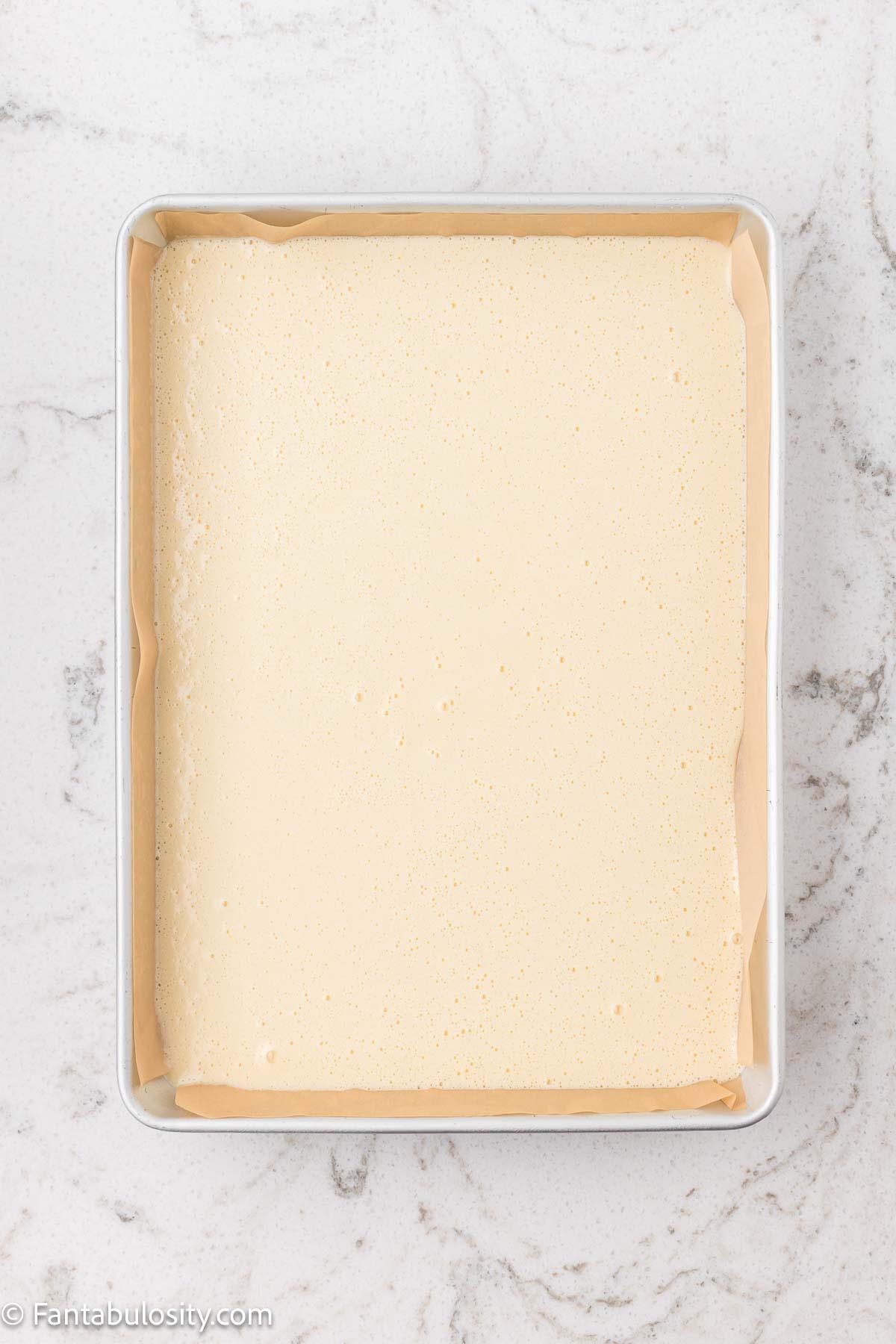 Tandy cake batter poured in to a 9x13 baking dish.