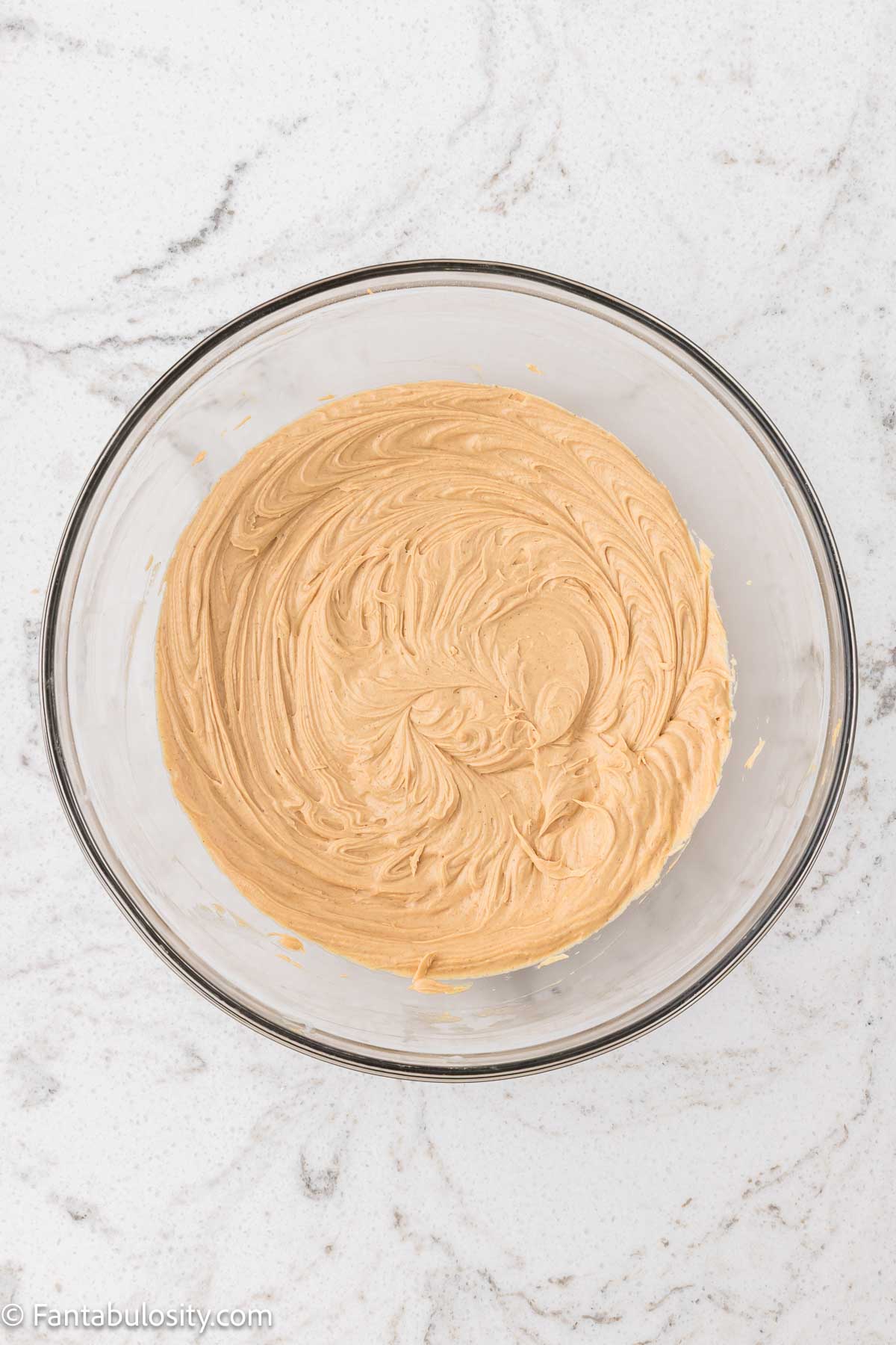 Creamy peanut butter frosting in mixing bowl.