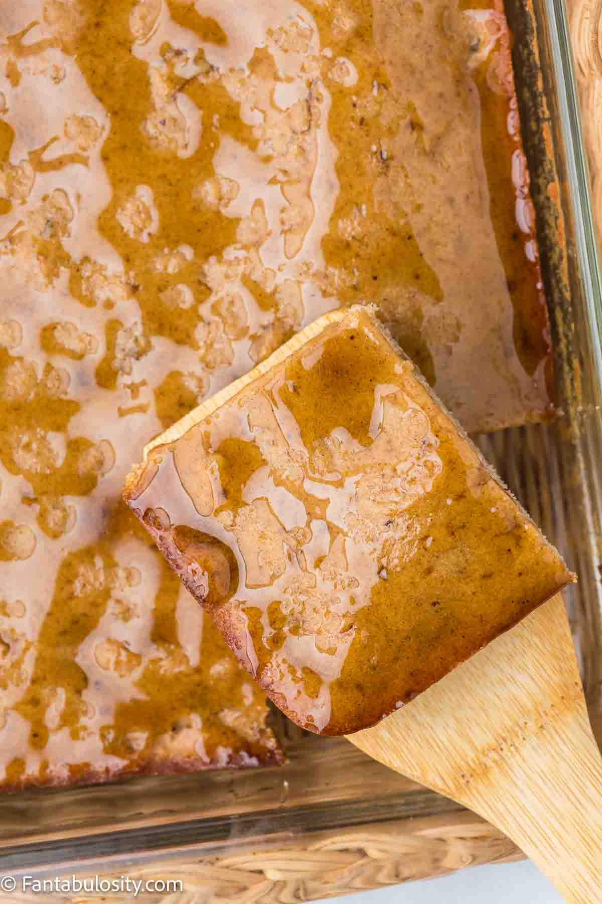 Amish applesauce cake with a slice cut out and lifted out.
