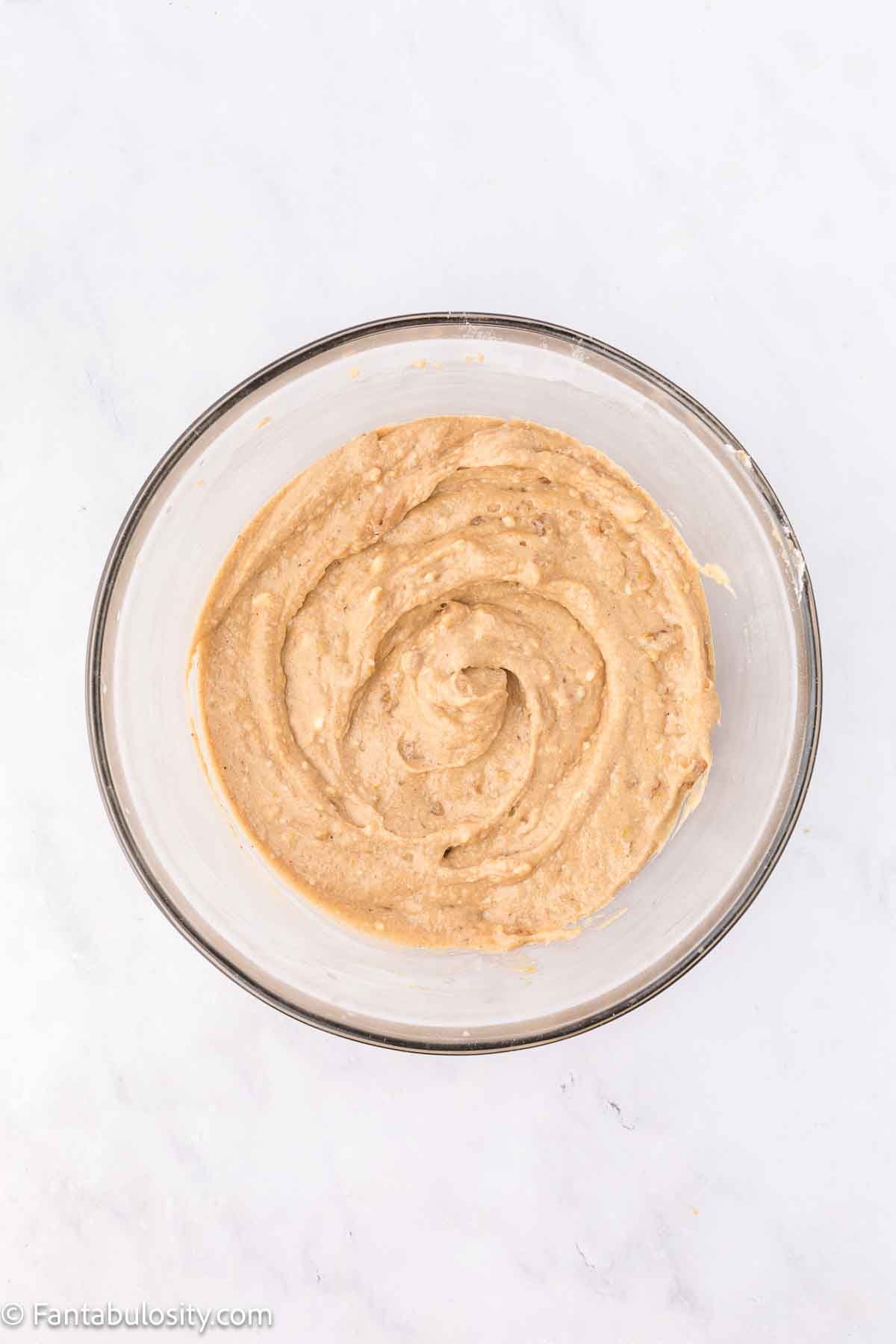 Dry ingredients combined with wet ingredients in mixing bowl.