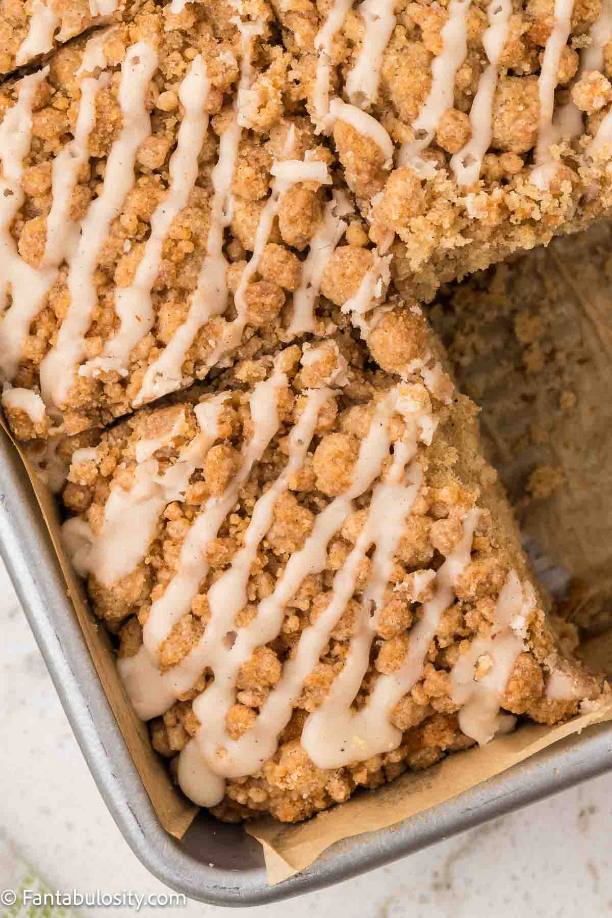 Applesauce crumb cake sliced in baking pan.