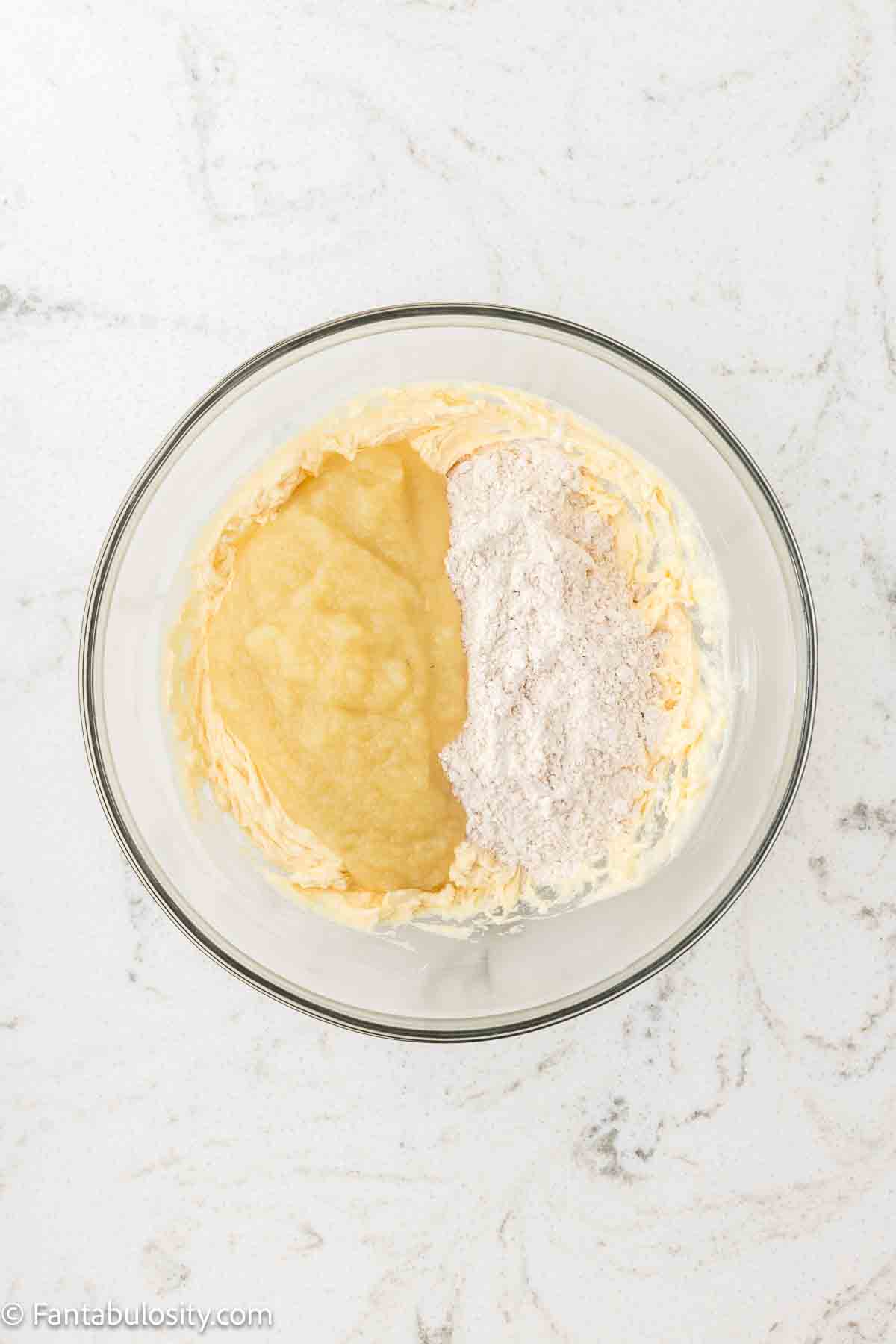 Applesauce and dry ingredient mixture added to butter and sugar in mixing bowl.
