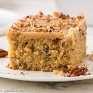 A slice of butter pecan cake on a plate.