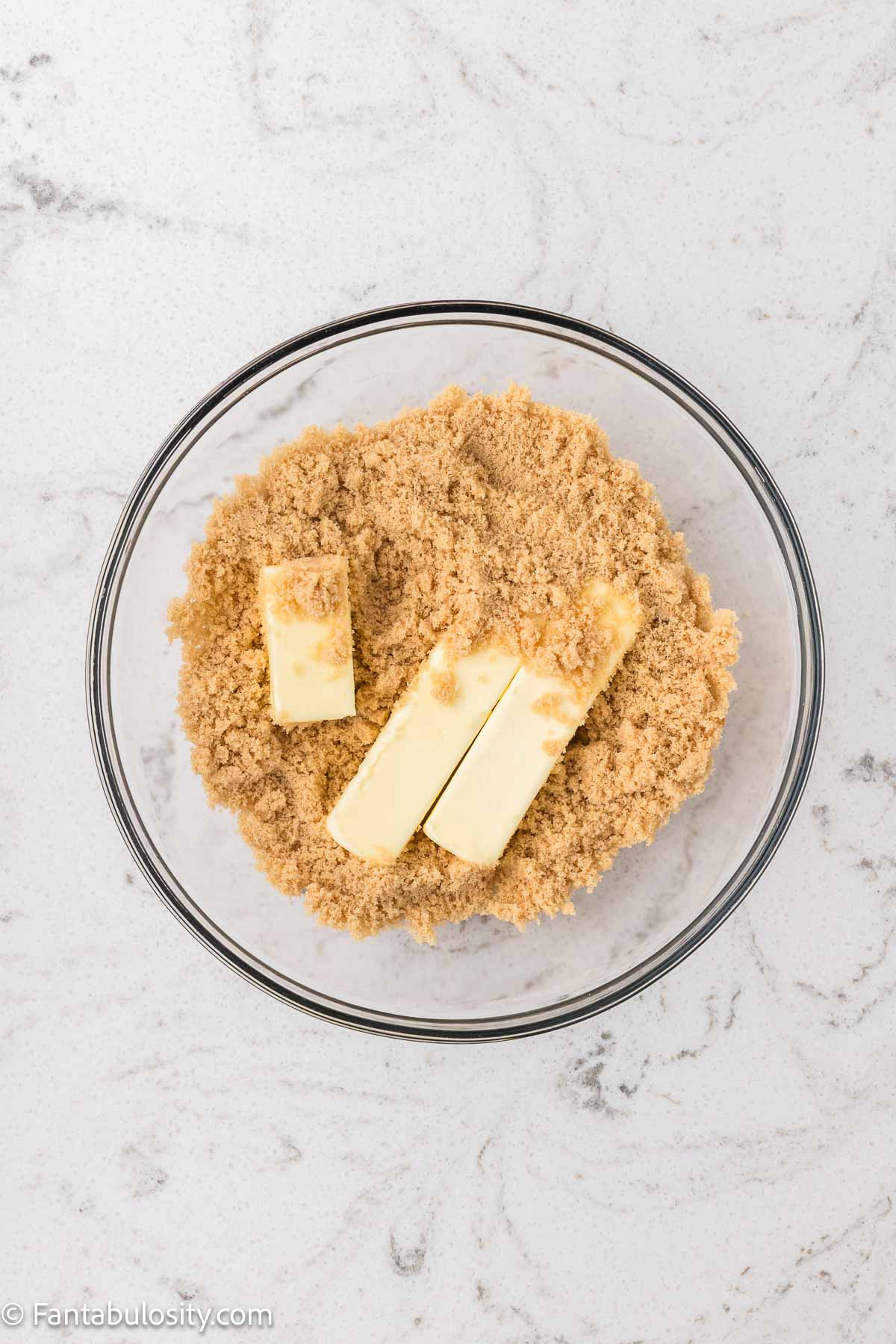 Brown sugar and butter in mixing bowl.