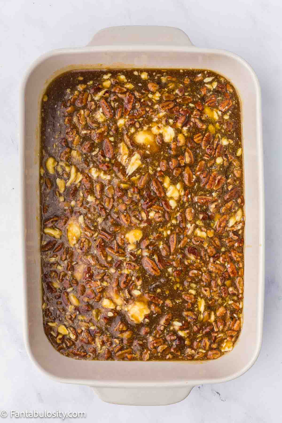 Sugar, corn syrup, butter, eggs and pecans mixed together and poured in to baking dish.