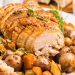 Crock Pot Boneless Turkey Breast on plate with vegetables.
