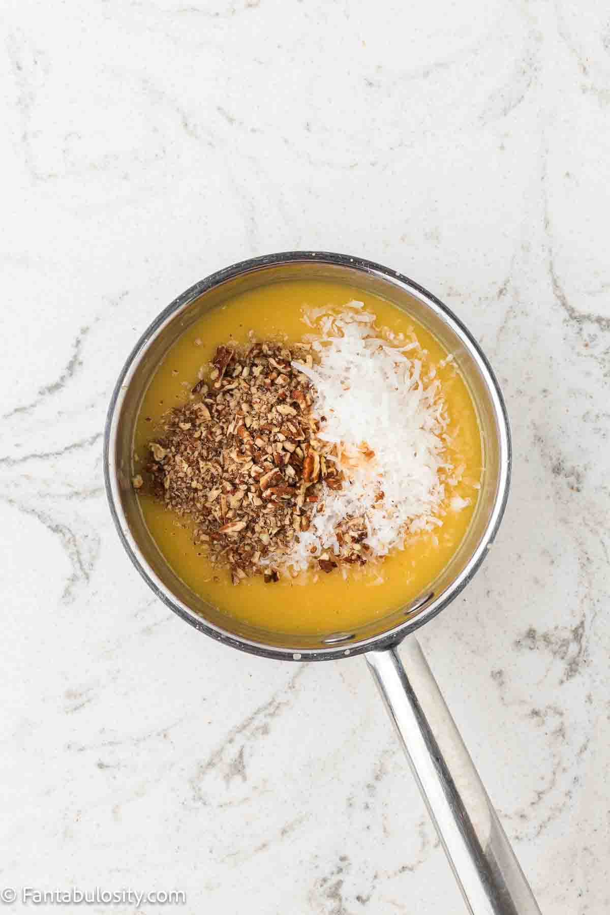 Egg yolks, coconut, nuts vanilla and evaporated milk in sauce pan for German Chocolate Cake topping.