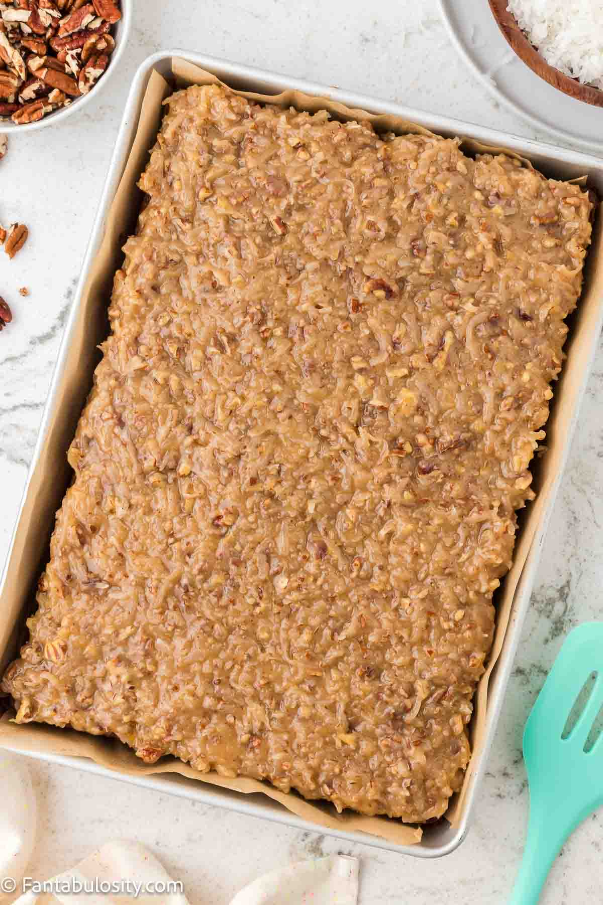 Frosted German Chocolate Cake in a 9x13 sheet pan.