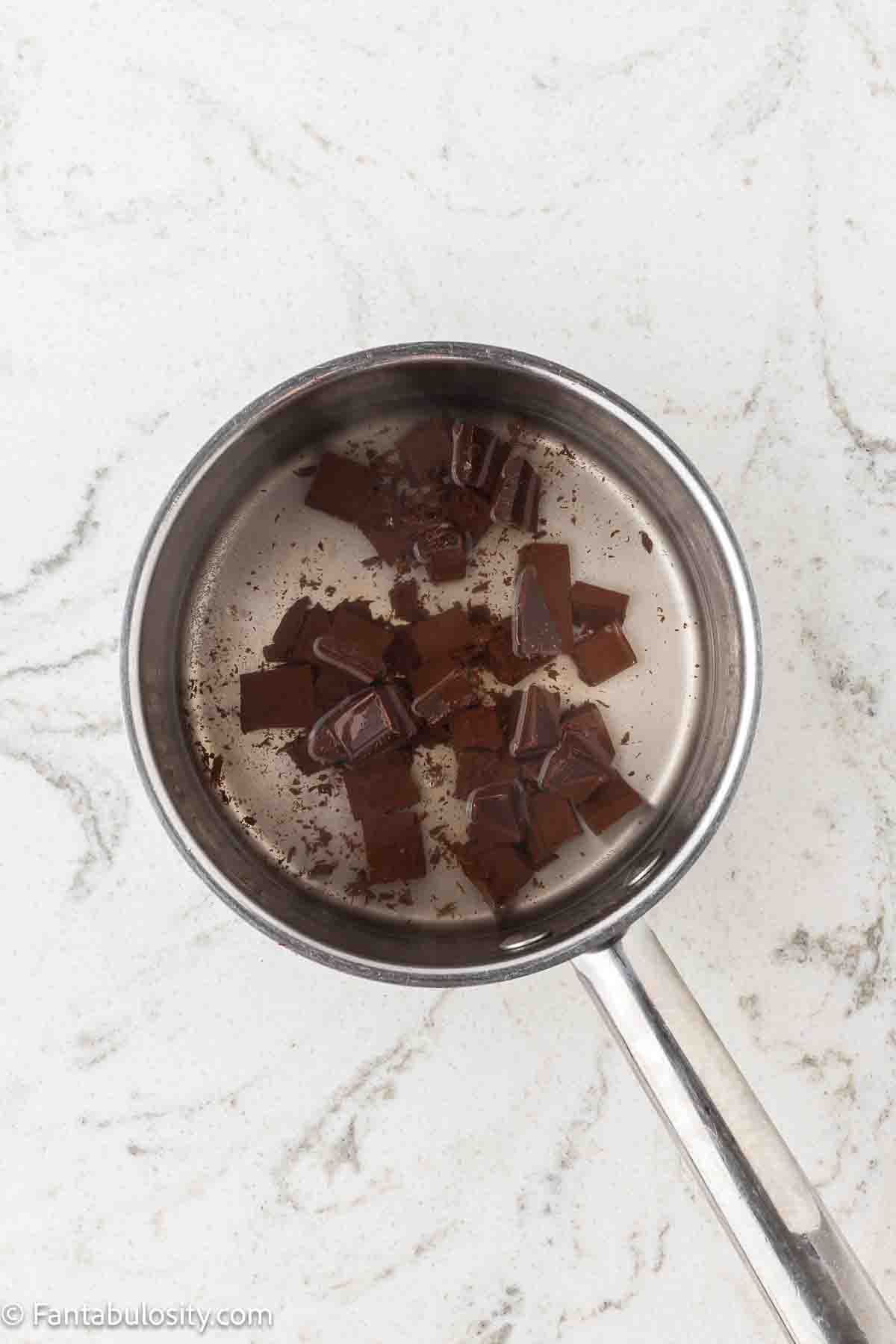 German baking chocolate in saucepan with water.