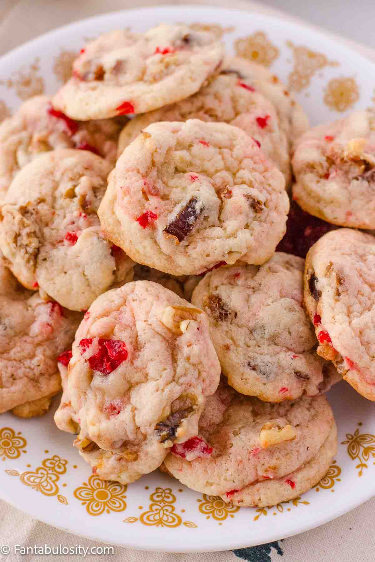 Cherry, dates, walnuts cookies on vintage plate.