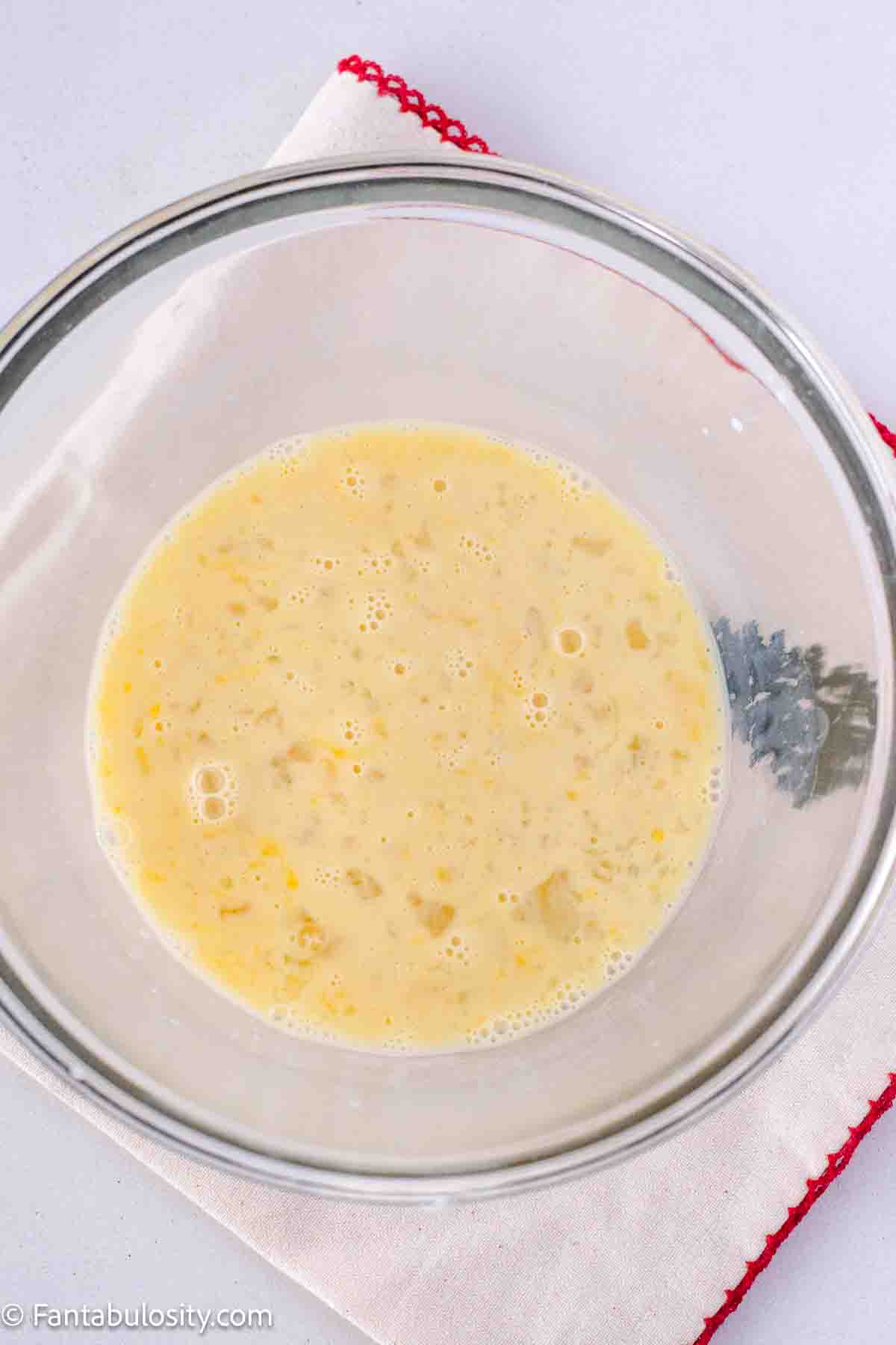 Eggs, milk, and vanilla in mixing bowl.