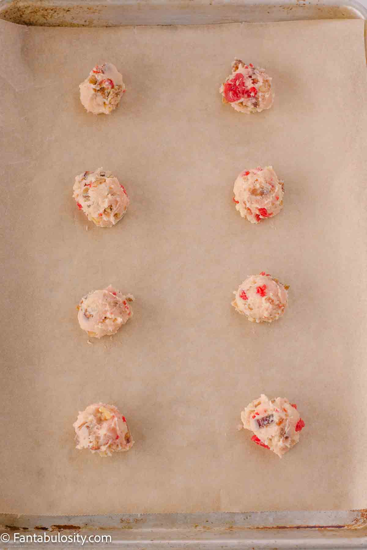 Cookie dough balls on cookie sheet. 