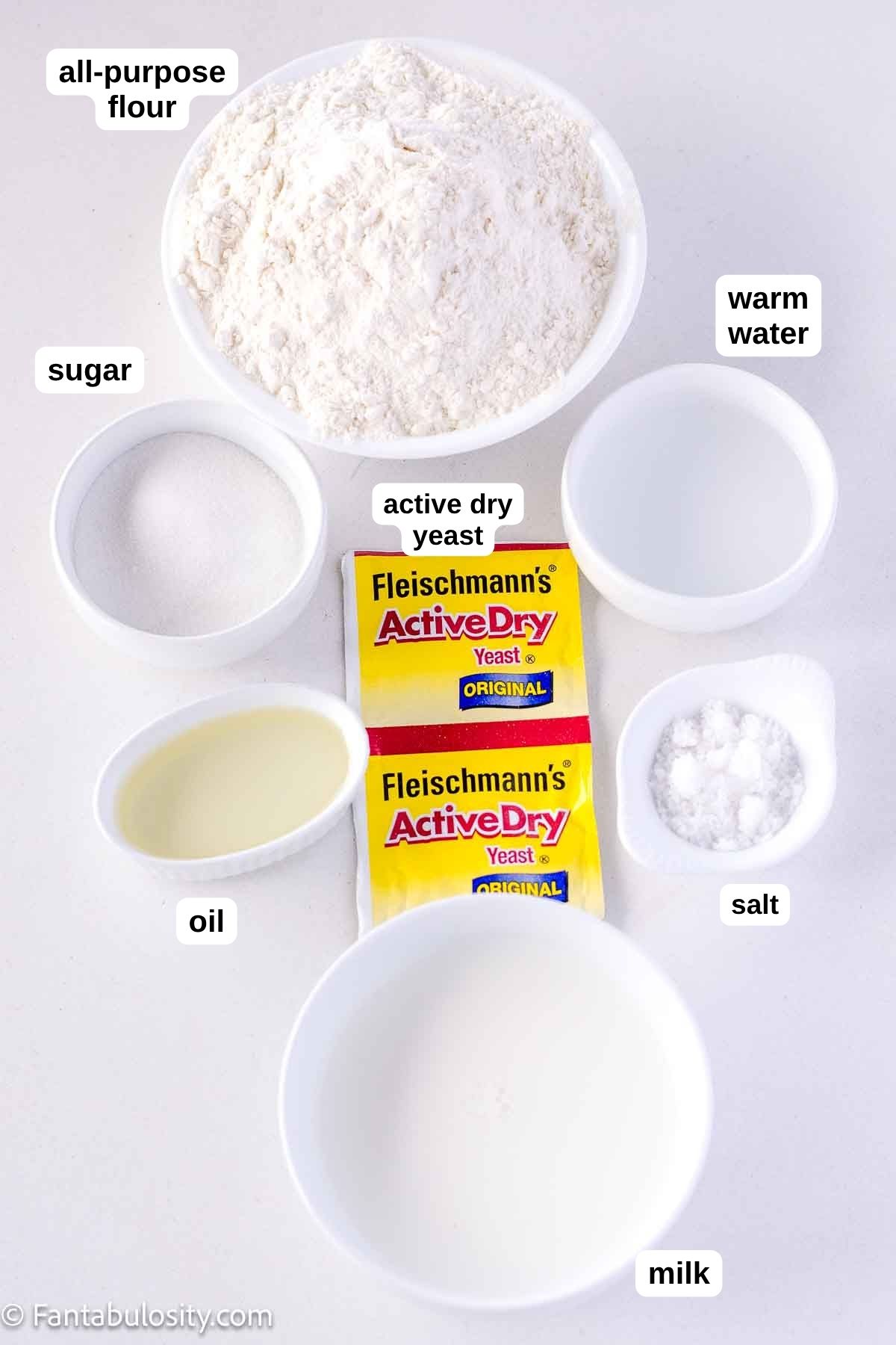 Labeled ingredients on table, to make an easy yeast rolls recipe.