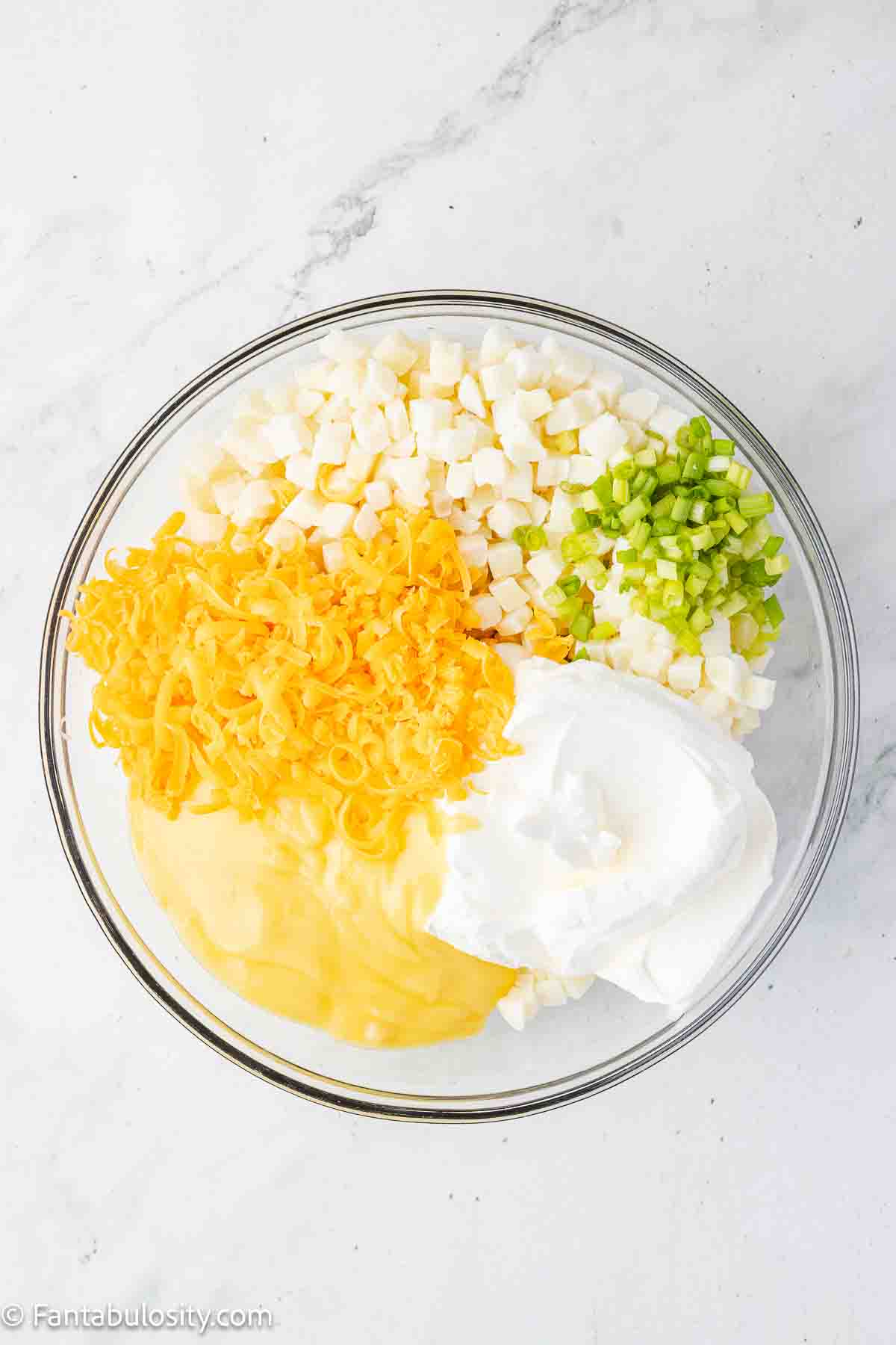 Party potatoes ingredients in big mixing bowl.