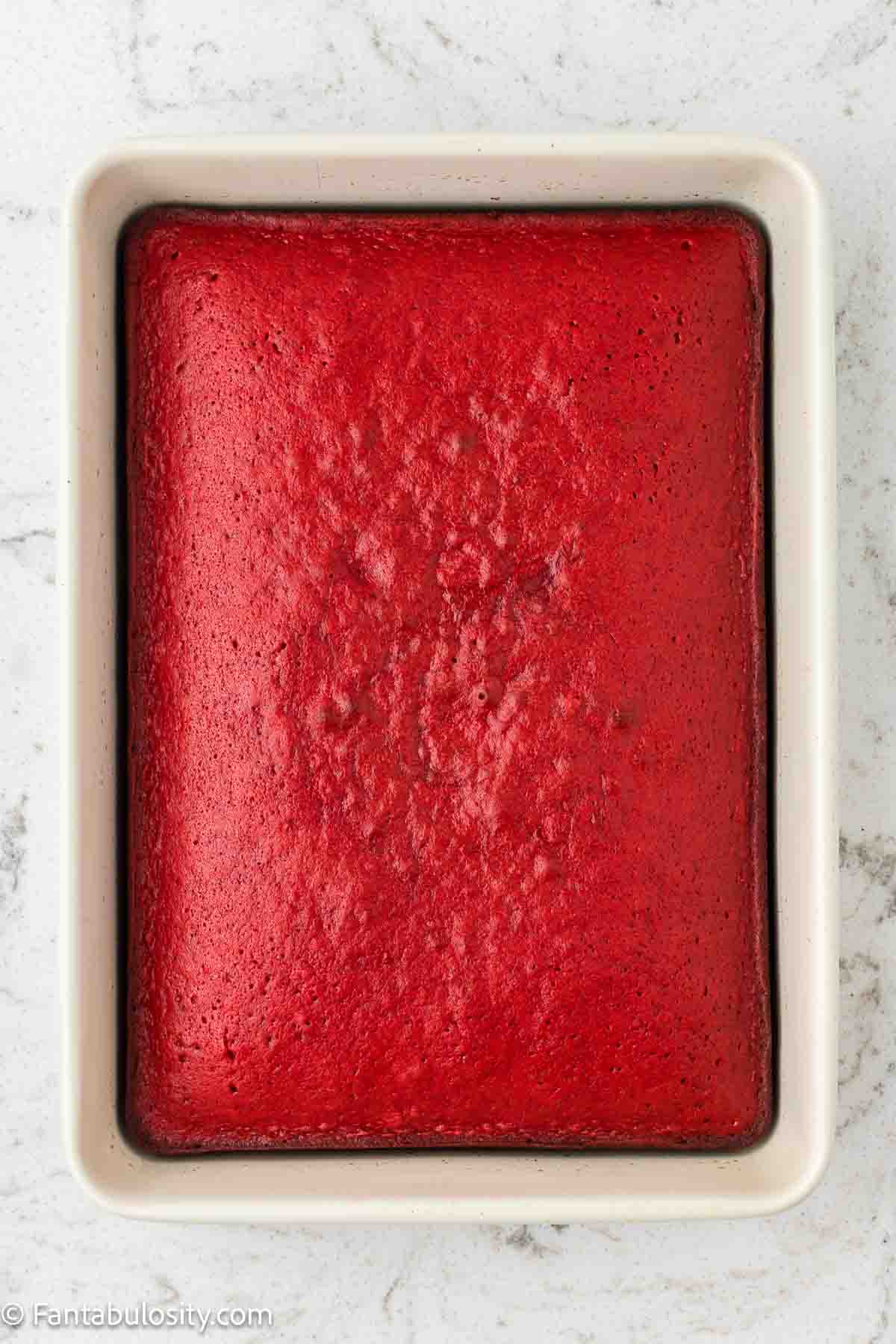 Baked red velvet sheet cake in 9x13 baking pan.