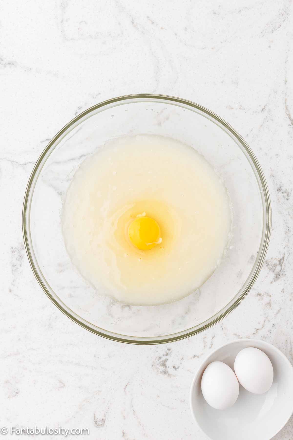 Sugar, oil and eggs in mixing bowl.
