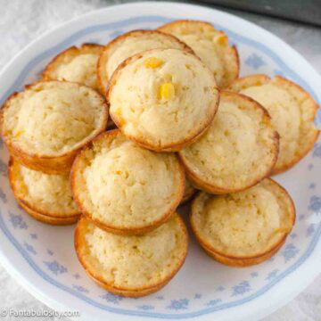 Sweet cornbread muffins stacked on a plate.