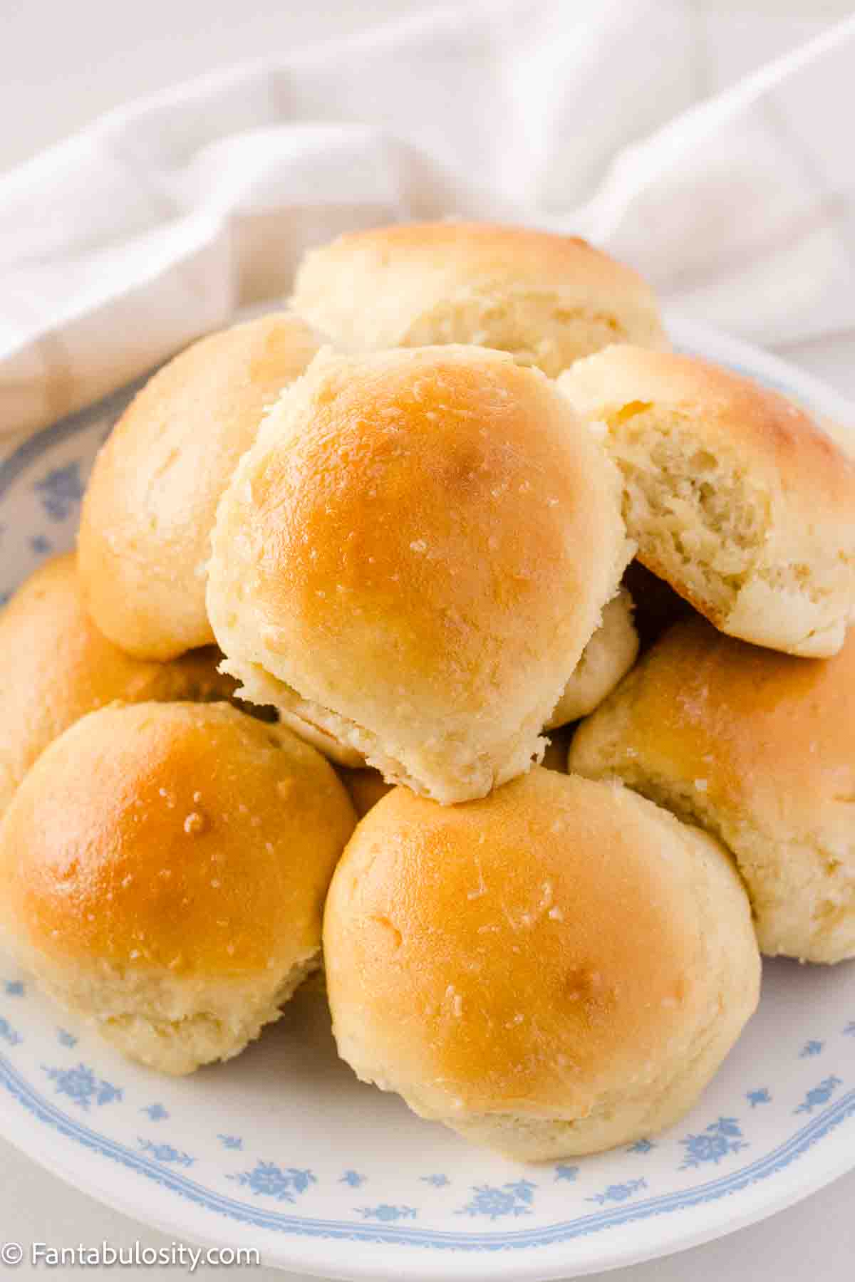 Homemade yeast rolls sitting on vintage Corelle plate.