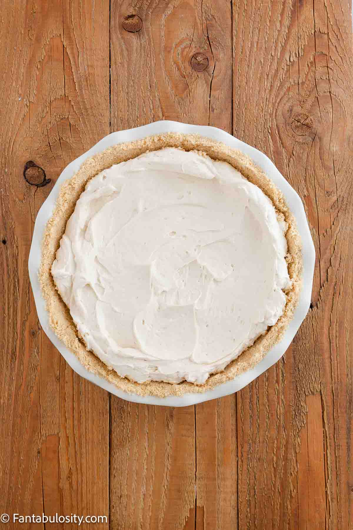 Caramel cream pie filling poured in to golden Oreo crust in pie plate.