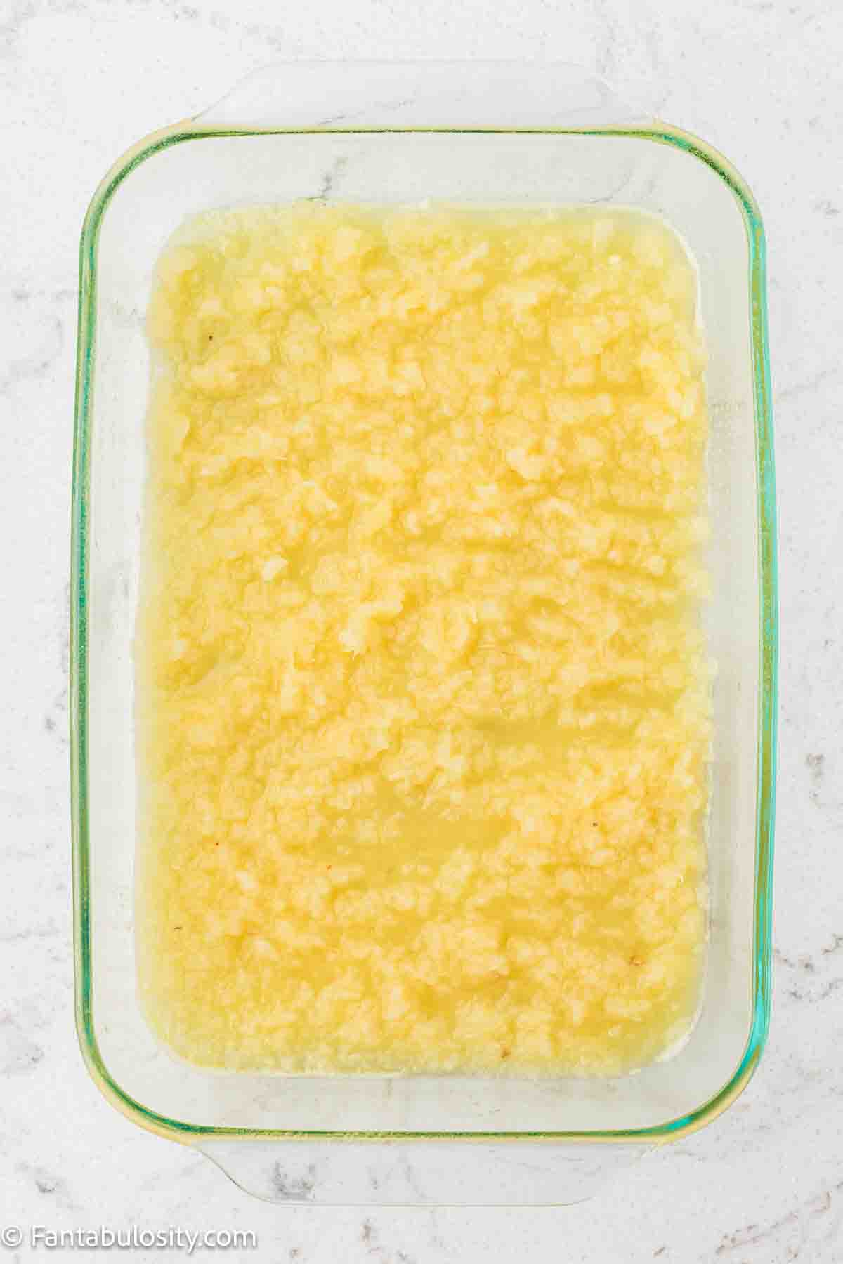 Crushed pineapple in 9x13 baking dish.