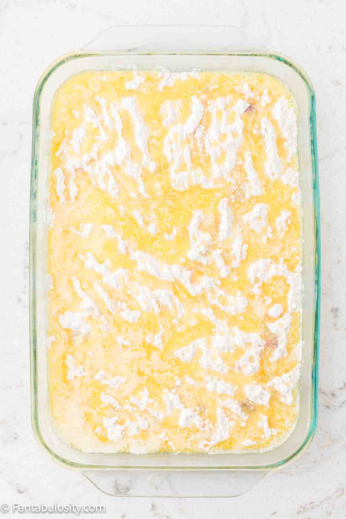 Melted butter poured over the top of the cake mix.