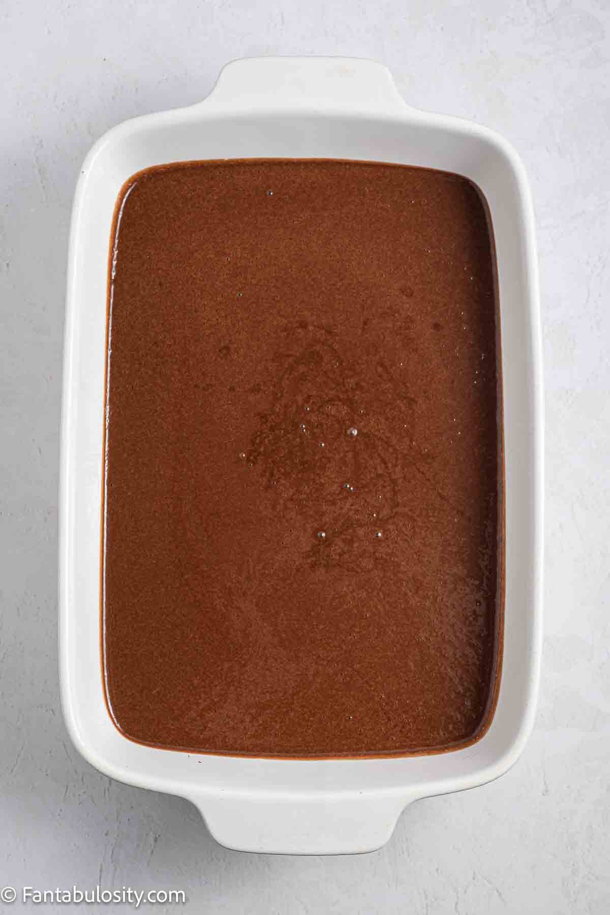 Chocolate tres leches cake batter in 9x13 baking dish.