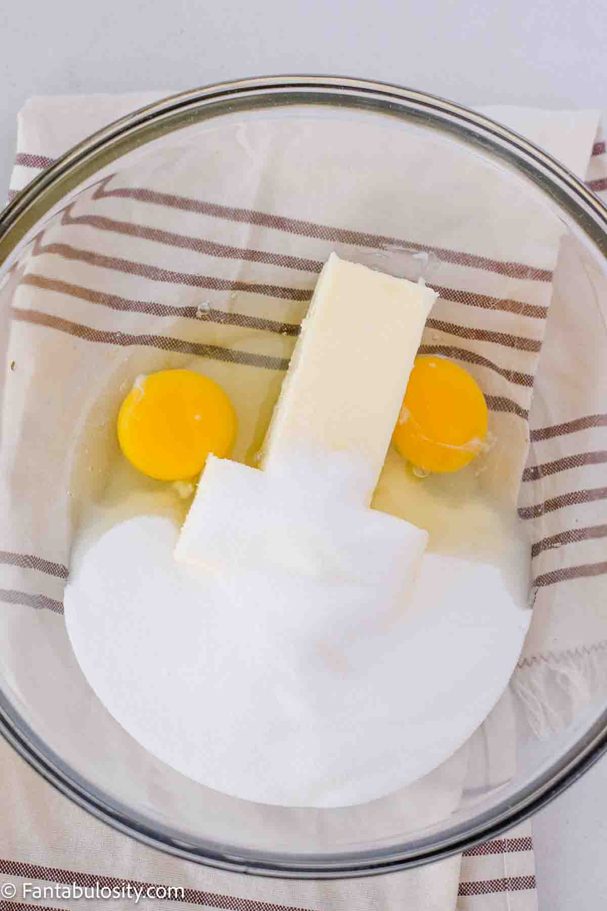 Butter, sugar and eggs in mixing bowl.