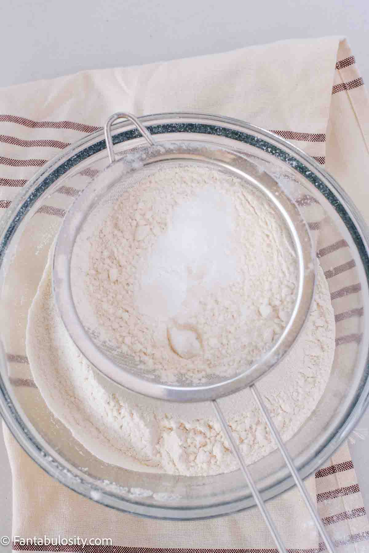 Flour, baking soda and salt in sifter over mixing bowl.