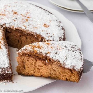 A slice of supper cake, being removed from rest of cake.