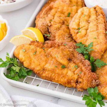 Fried Catfish on a platter with fresh parsley.