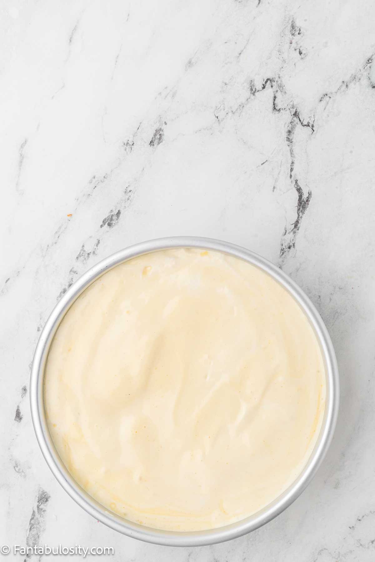 Cloud cake batter poured in to round cake pan.