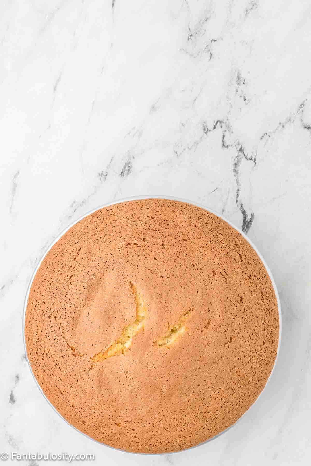 Baked cloud cake in round cake pan.