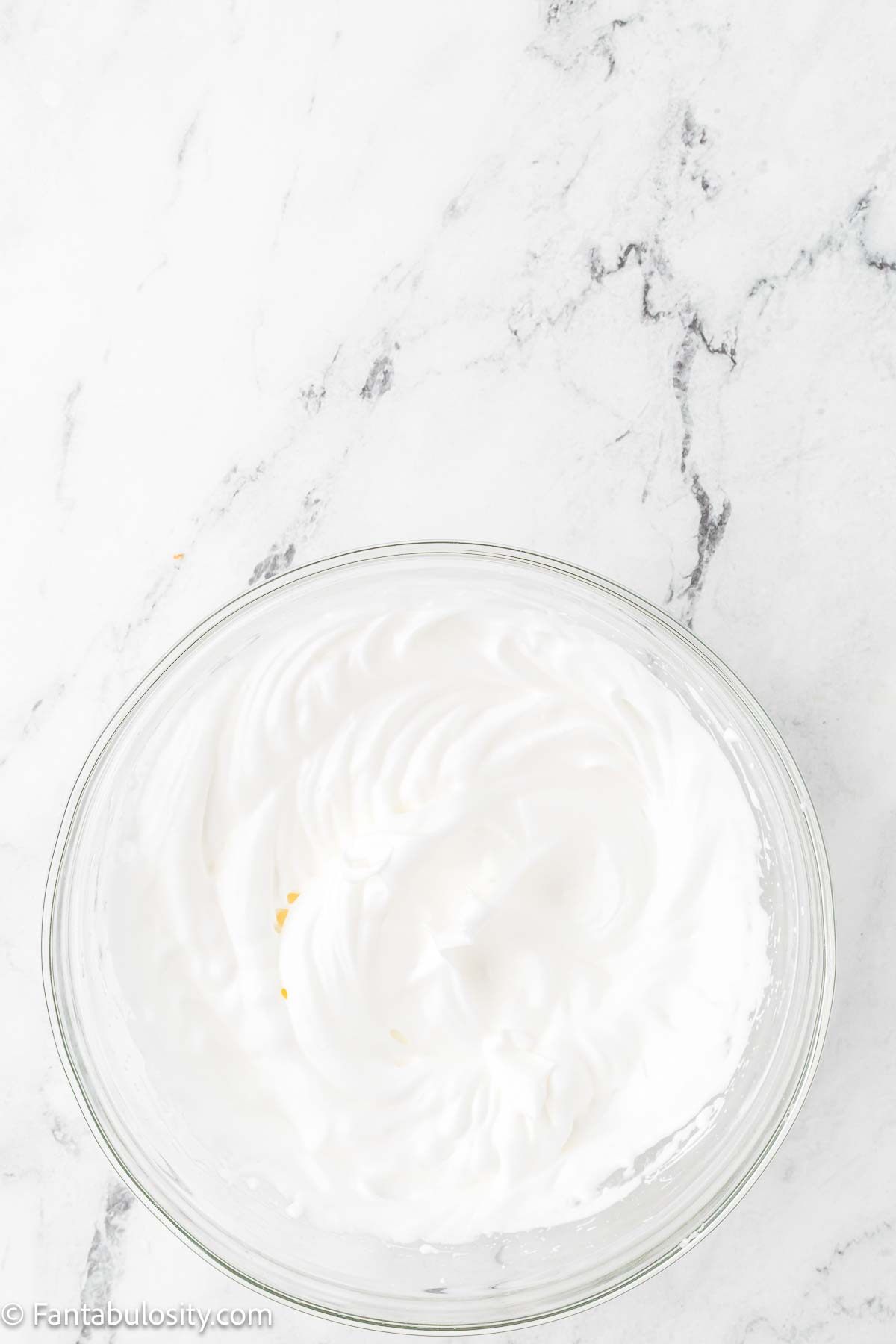 Egg whites and sugar in mixing bowl.