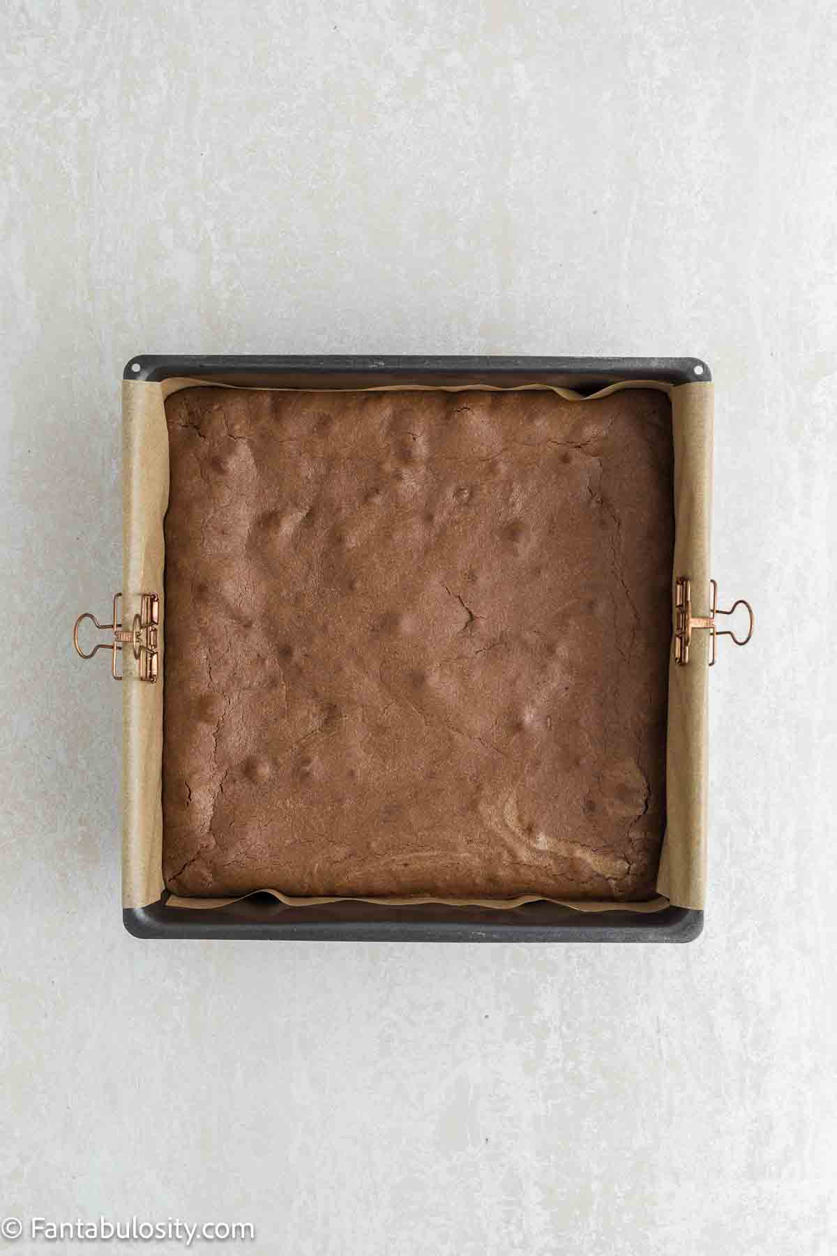 Baked condensed milk brownies in square baking pan.