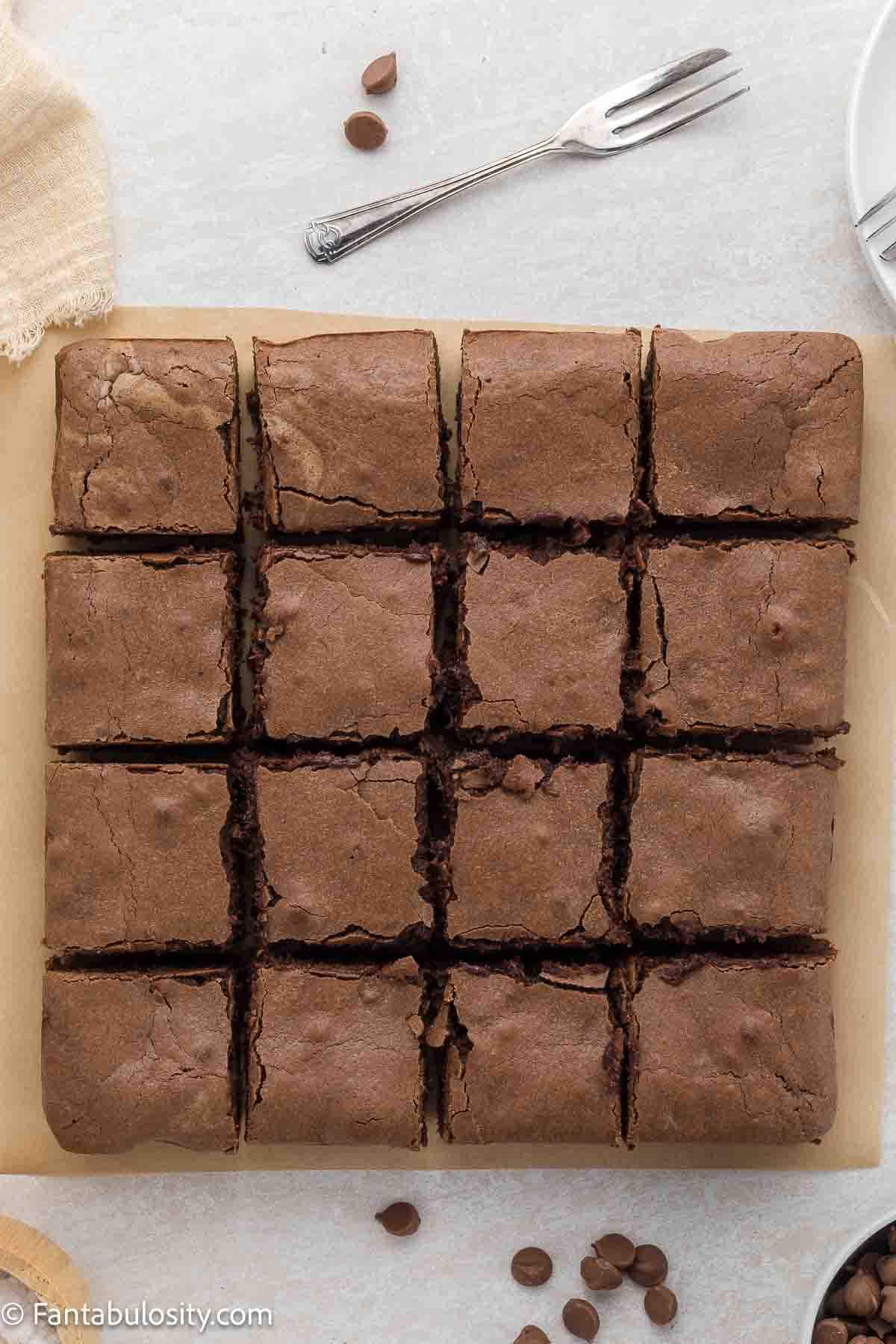 Cut condensed milk brownies on the counter.