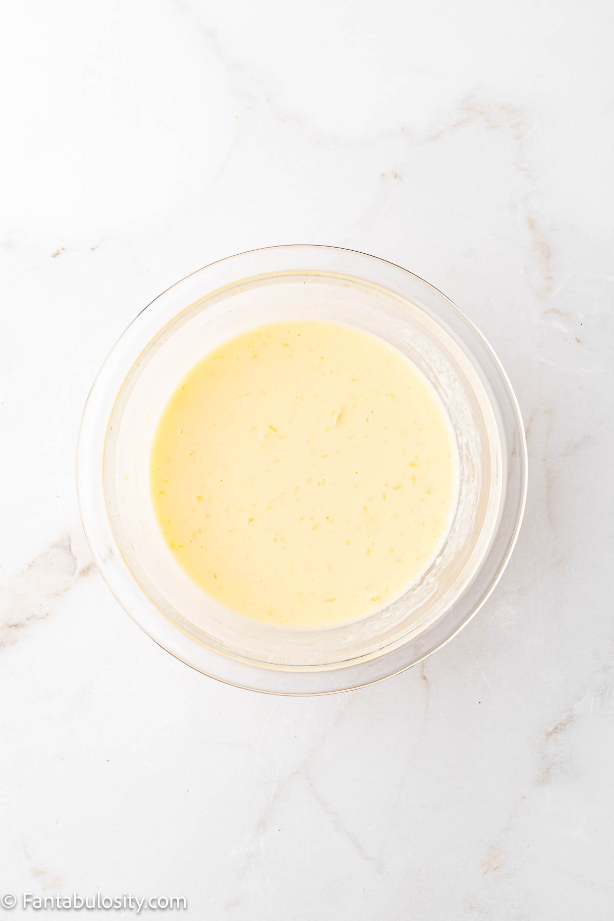 Egg and buttermilk mixed together in mixing bowl.