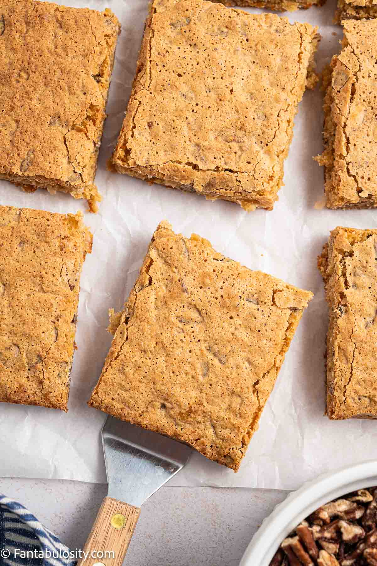 Sliced sad cake on parchment paper.
