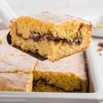 A square slice of sock it to me cake on a spatula.