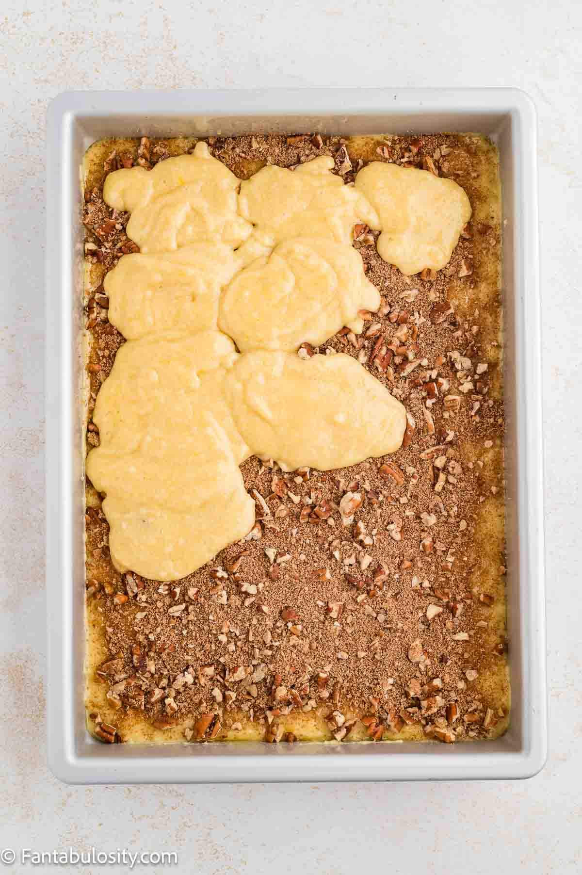 Cake batter, filling and more cake batter poured in to 9x13 baking pan.