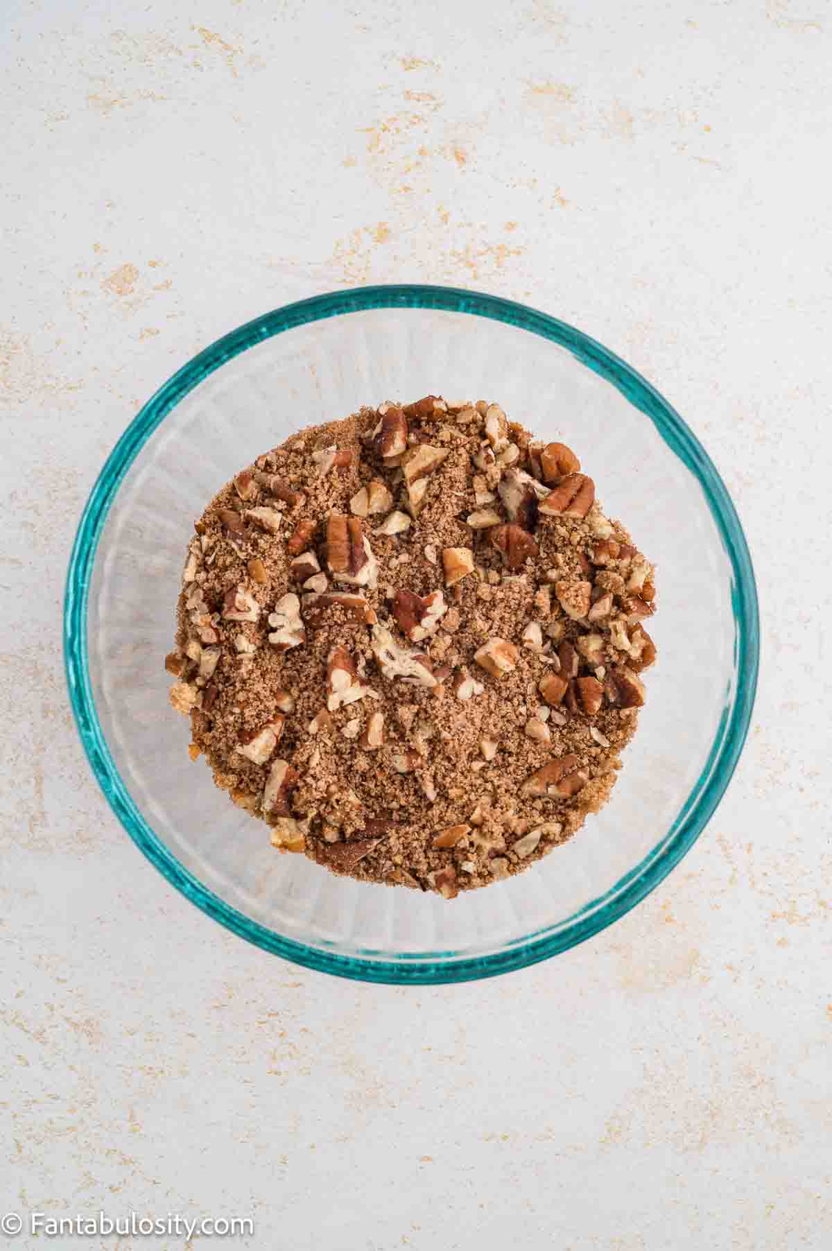 Pecans, brown sugar and cinnamon in mixing bowl for cake filling.