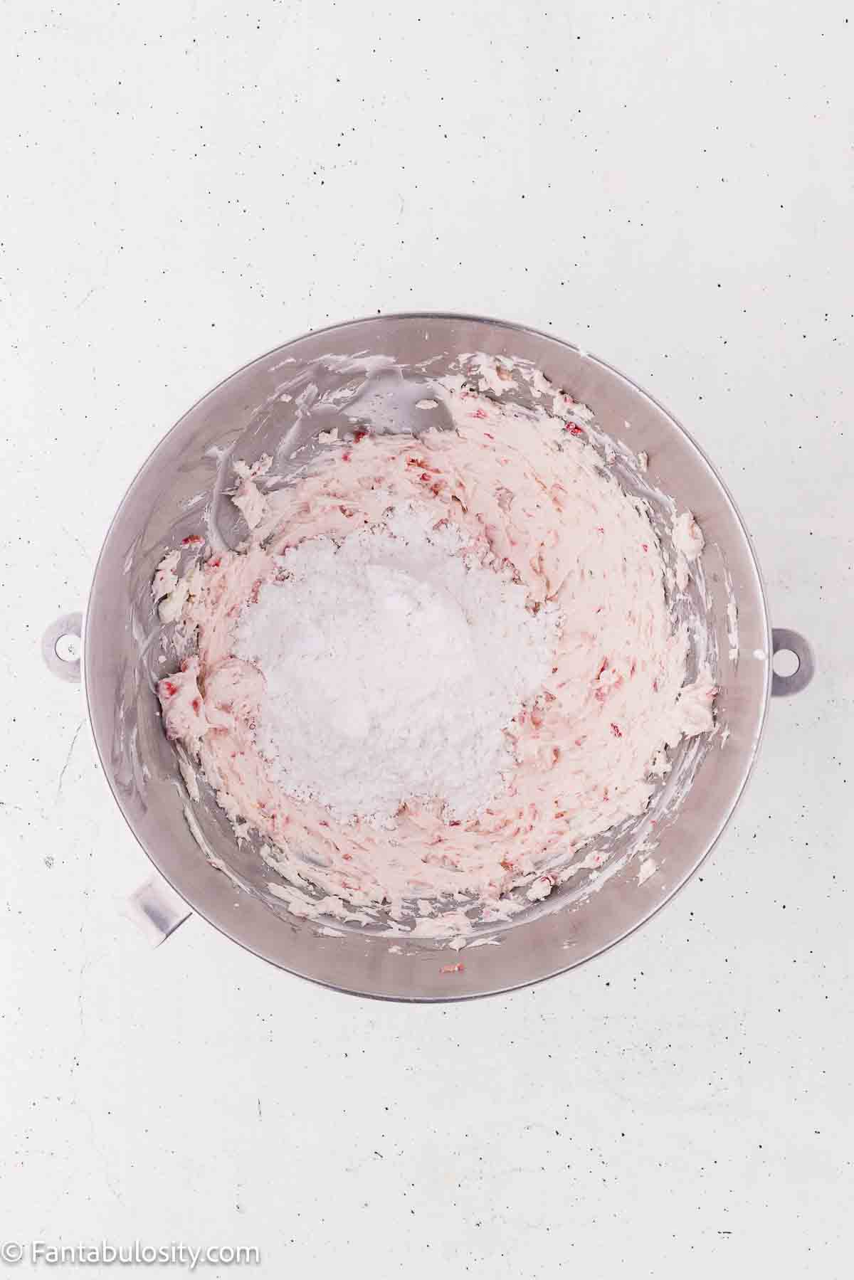 Cream cheese, strawberries and powdered sugar in mixing bowl.