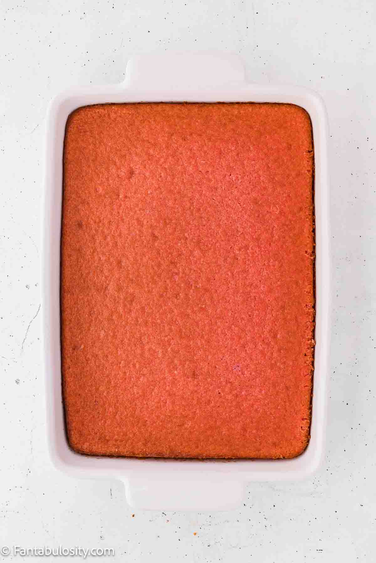 Strawberry jello cake baked in a 9x13 baking dish.