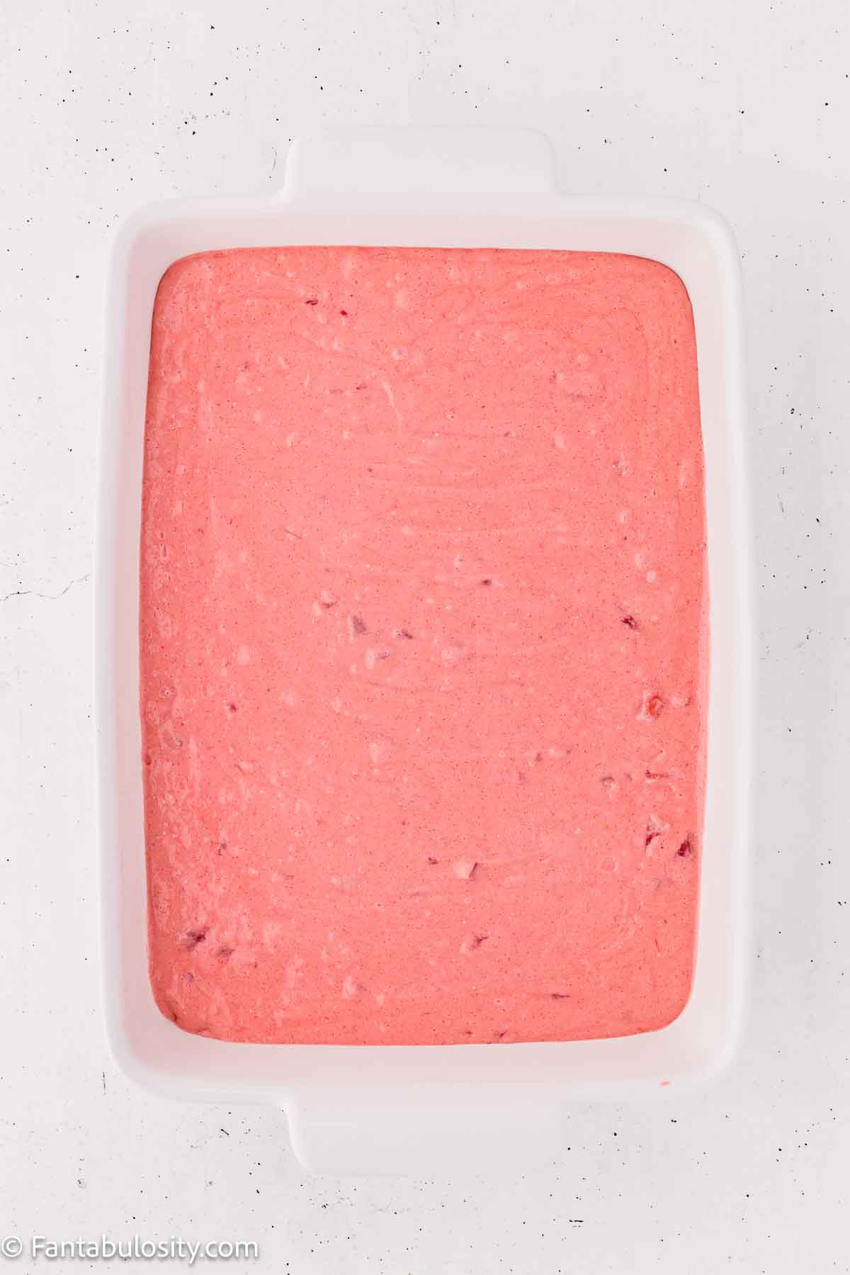 Strawberry jello cake batter poured in to 9x13 baking dish.