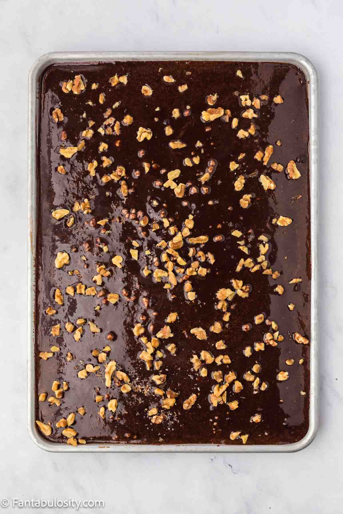 Texas sheet cake frosting with walnuts.