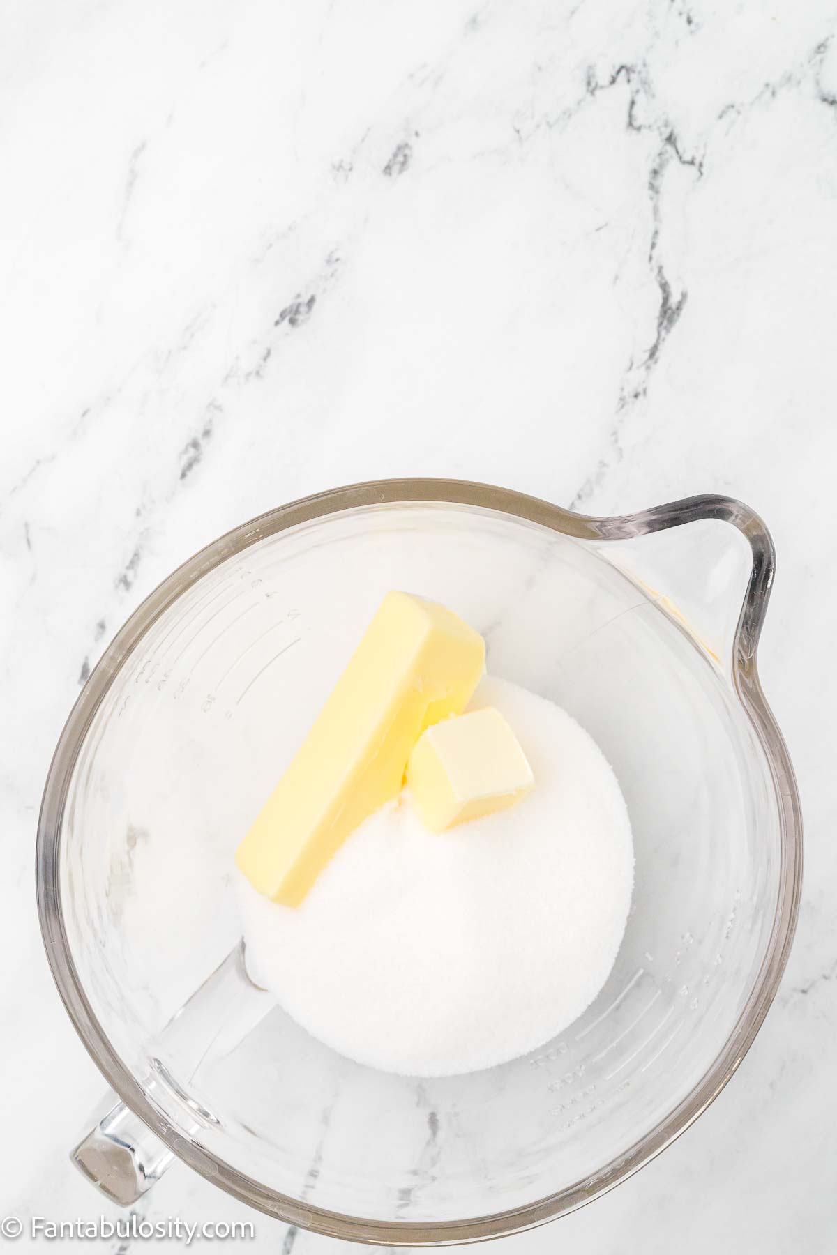 Butter and sugar in mixing bowl.