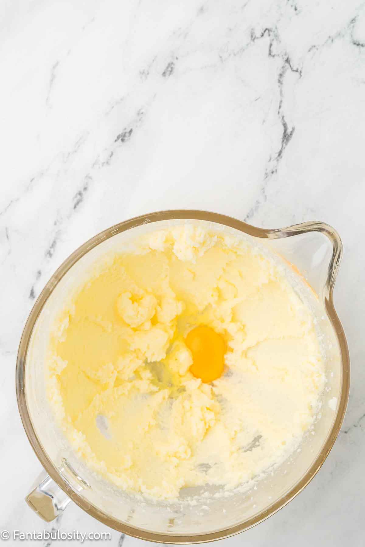 Eggs added to butter and sugar in mixing bowl.
